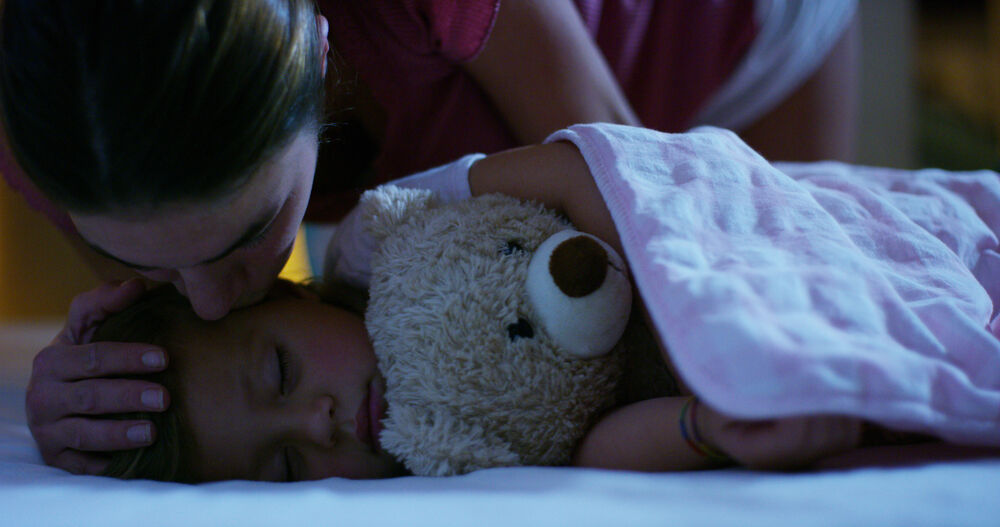 A toddler sleeping in bed 