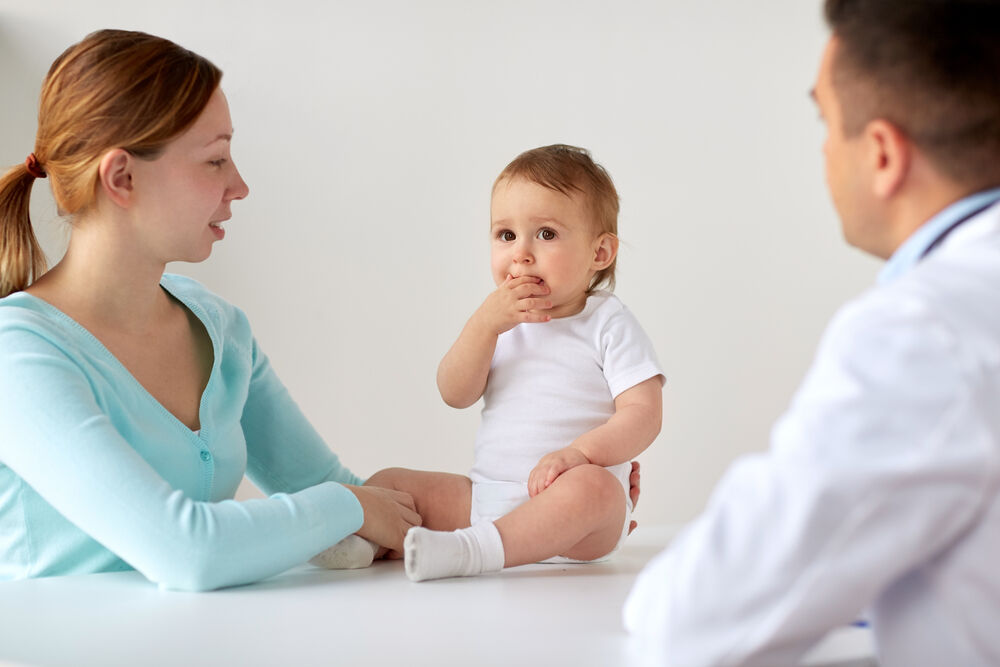A pediatrician examining a baby with diarrhea