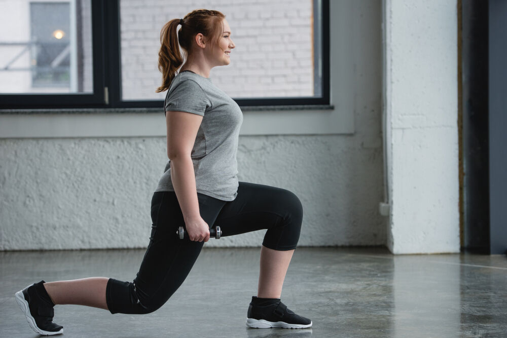 A body positive woman exercising on her period