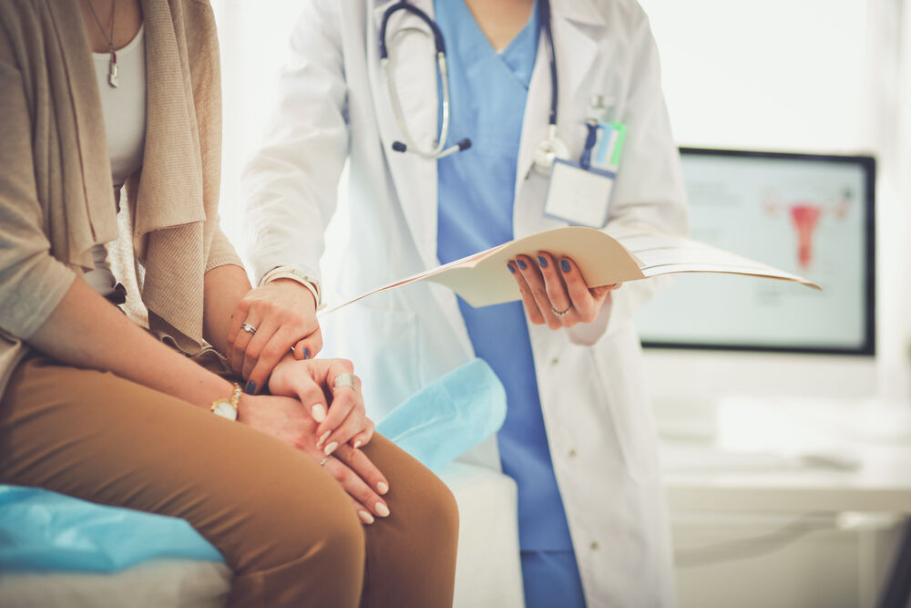 Doctor and patient discussing black period blood