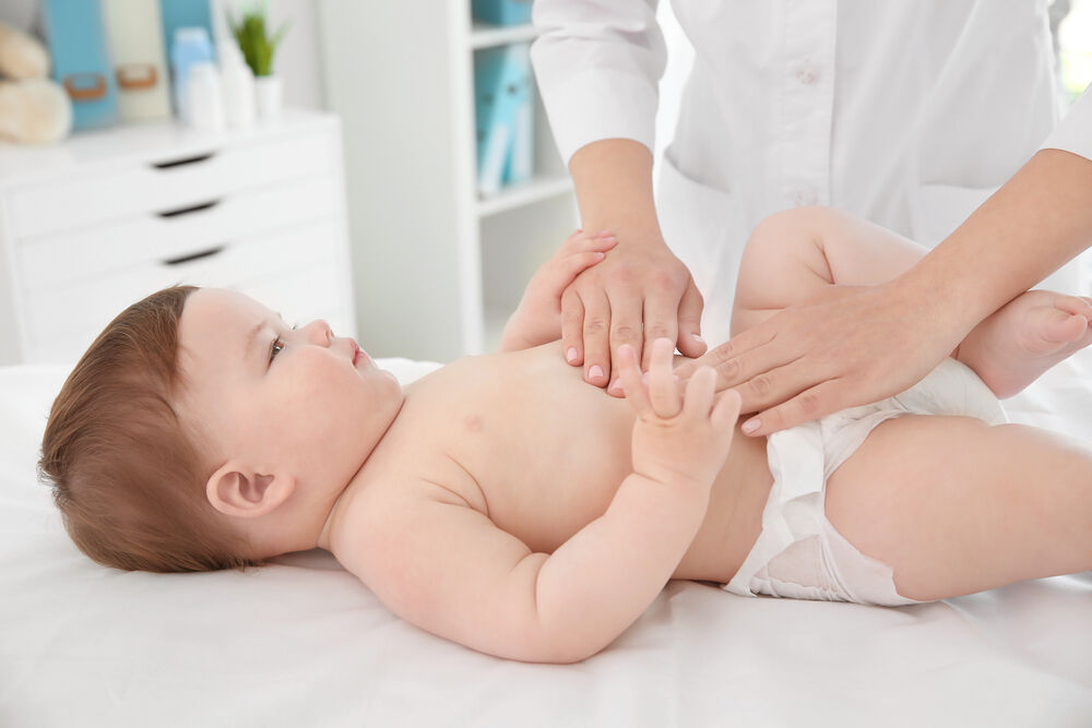 A doctor examines a 9-month-old baby