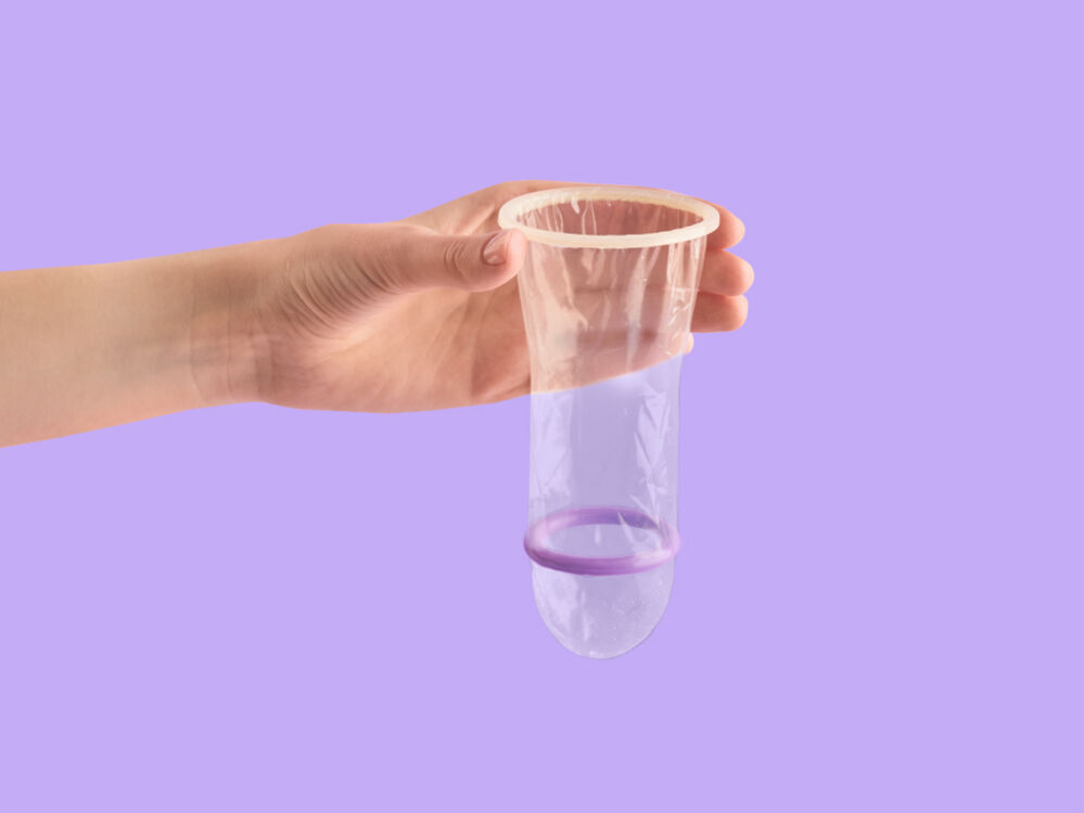 female condom against a purple background