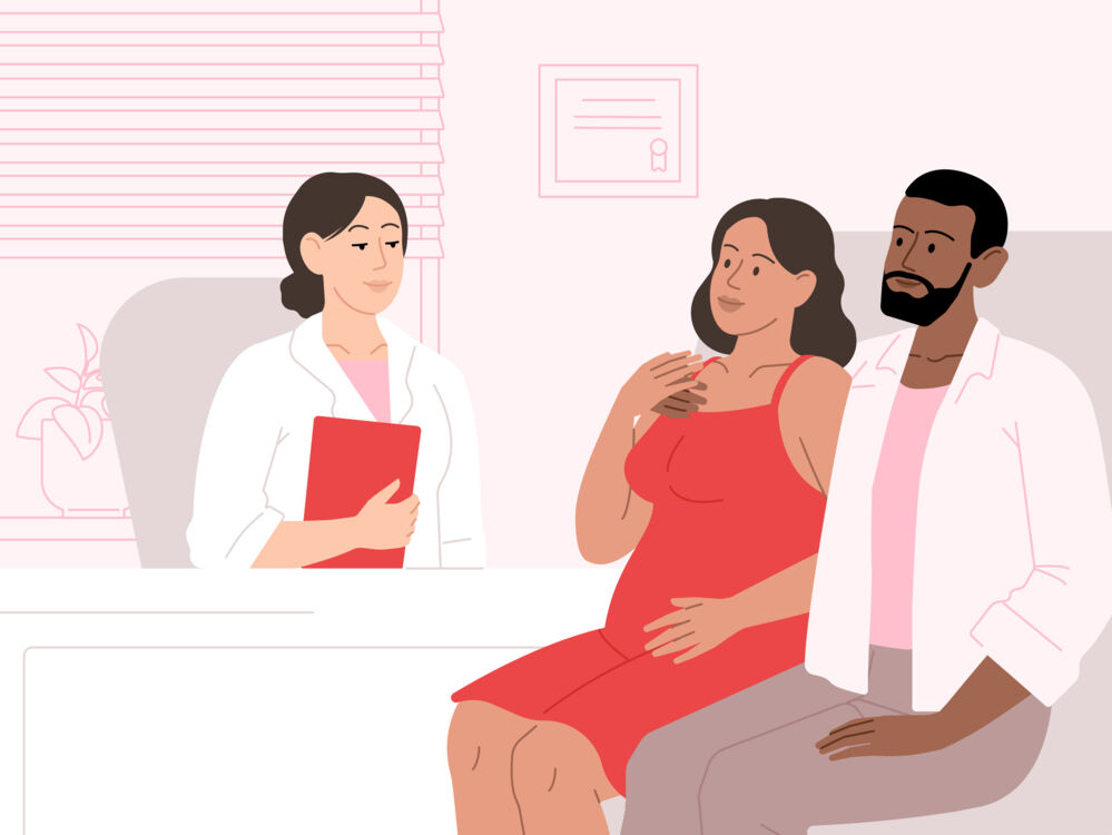 pregnant couple talking to doctor