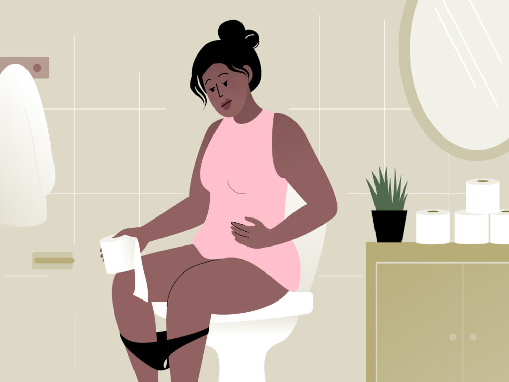 woman sitting on a toilet because of period poop 