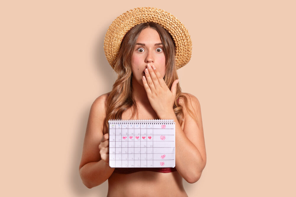 A woman calculating her cycle and wearing period swimwear
