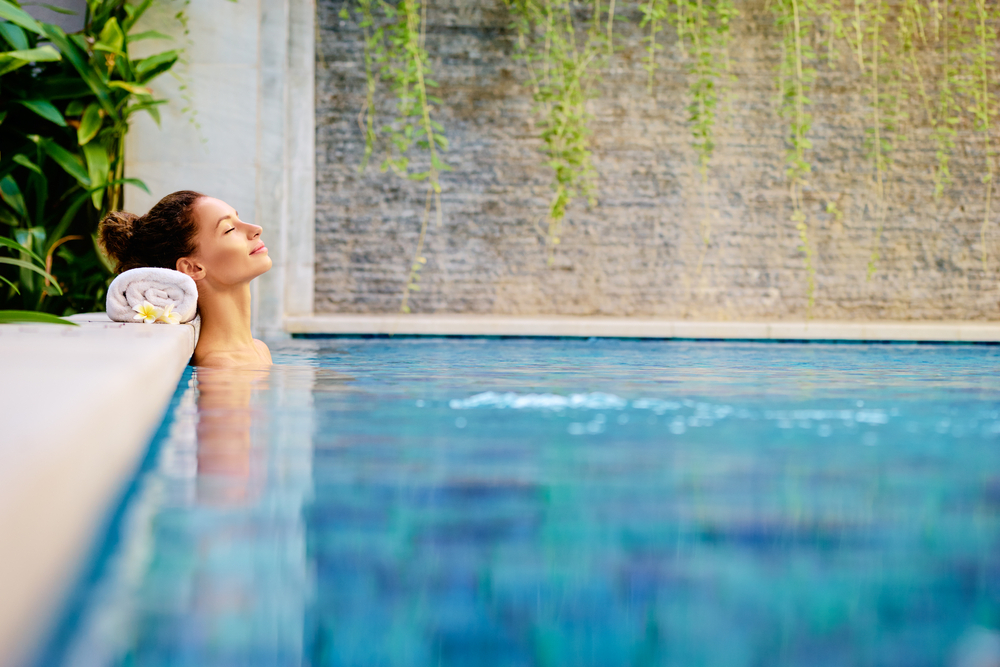 woman relaxing in outdoor spa swimming pool woman relaxing in outdoor spa swimming pool