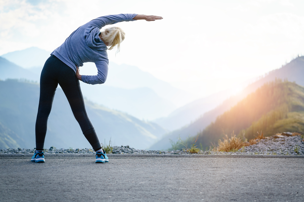 Athlete at the top of the mountain doing workout Athlete at the top of the mountain doing workout