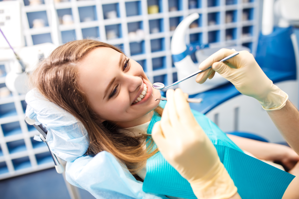 Woman at the dentist's chair during a dental procedure Woman at the dentist's chair during a dental procedure