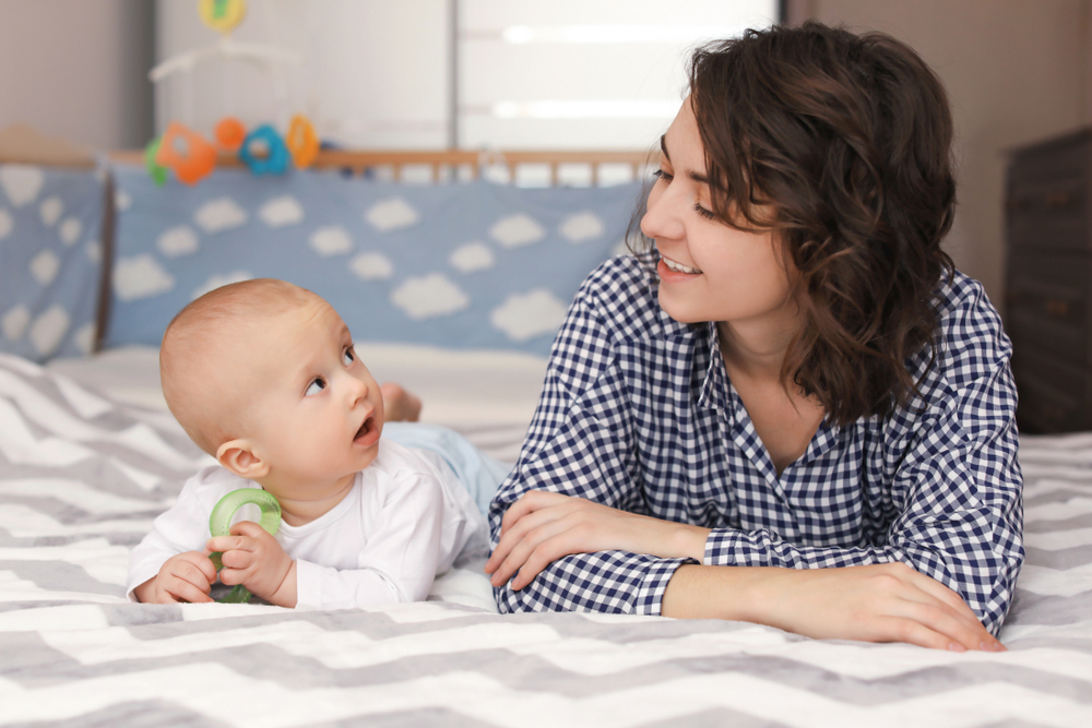 A baby holding a baby teether A baby holding a baby teether