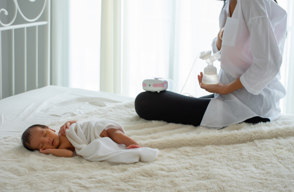 A woman using free automatic breast pump A woman using free automatic breast pump