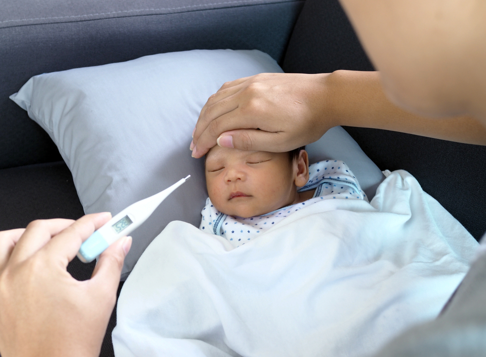 A mom measures baby's temperature A mom measures baby's temperature