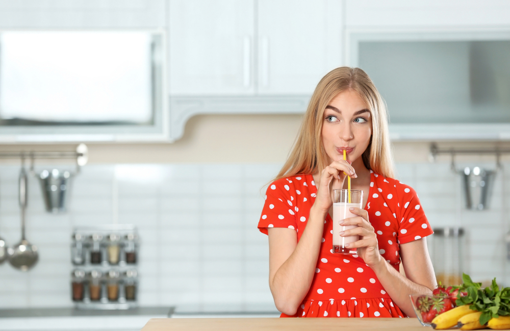 Young female drinking placenta smoothie Young female drinking placenta smoothie