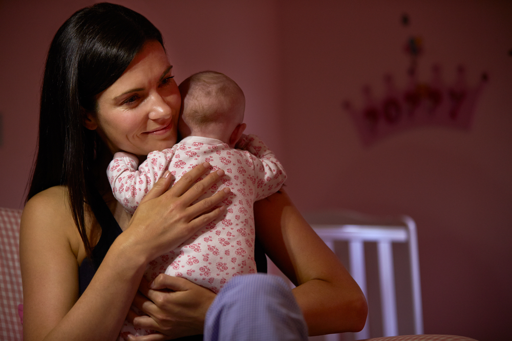 A woman dealing with separation anxiety in babies at night A woman dealing with separation anxiety in babies at night