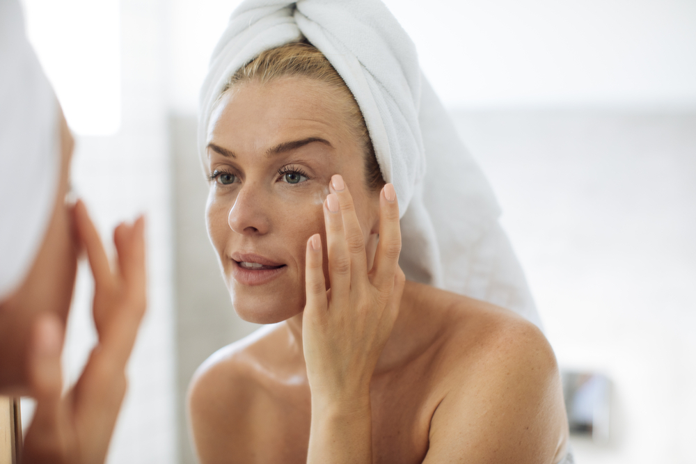 A woman uses vitamin-enriched cream to get rid of crow’s-feet A woman uses vitamin-enriched cream to get rid of crow’s-feet