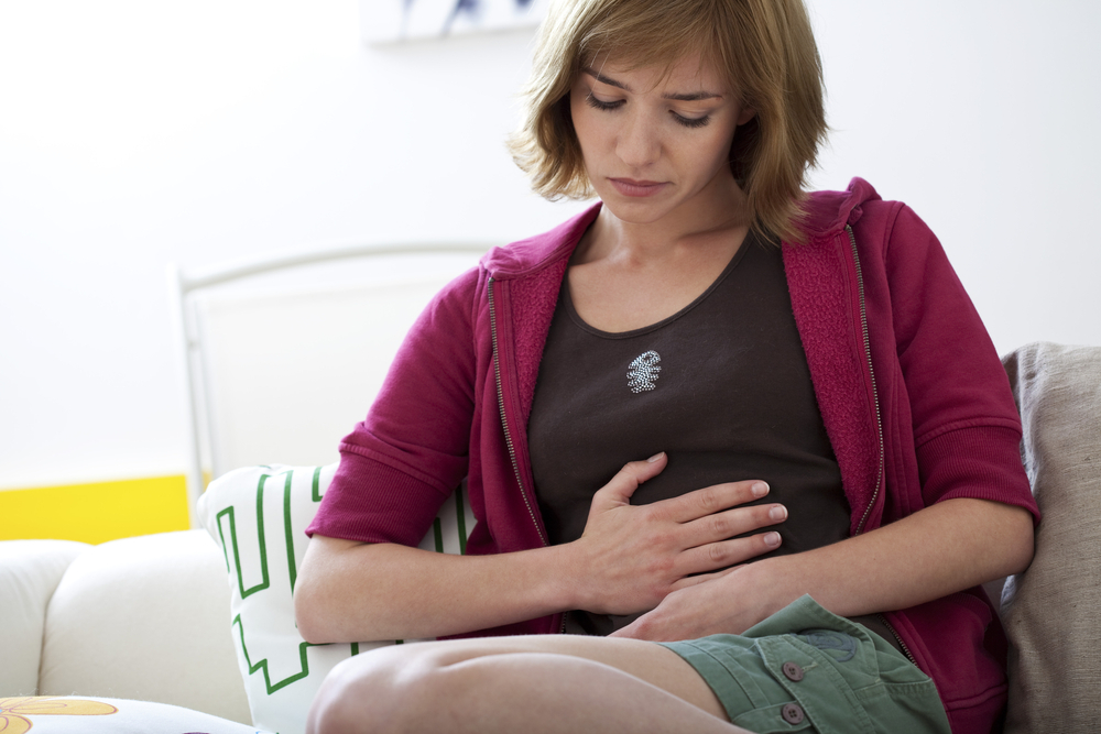 A woman experiencing ovulation bloating A woman experiencing ovulation bloating
