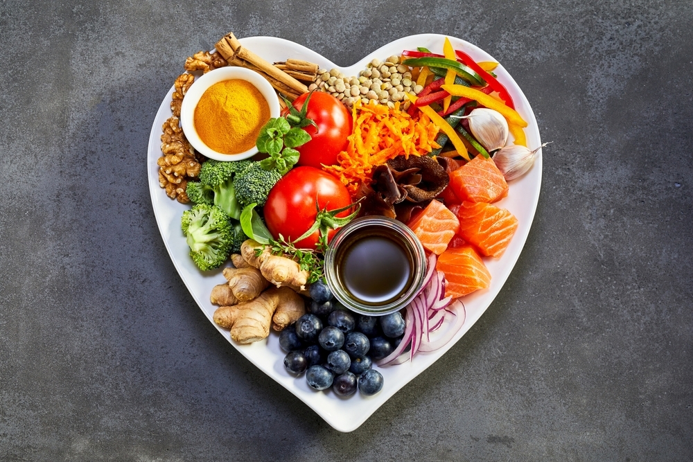 heart-shaped plate of acai, lentils, soy sauce, ginger, salmon, carrot, tomato, turmeric, cinnamon, walnuts heart-shaped plate of acai, lentils, soy sauce, ginger, salmon, carrot, tomato, turmeric, cinnamon, walnuts