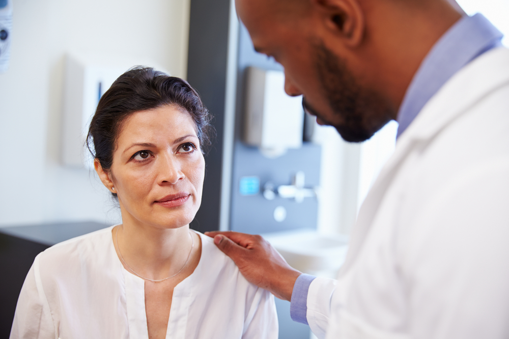 A woman is discussing postmenopausal bleeding with her doctor A woman is discussing postmenopausal bleeding with her doctor