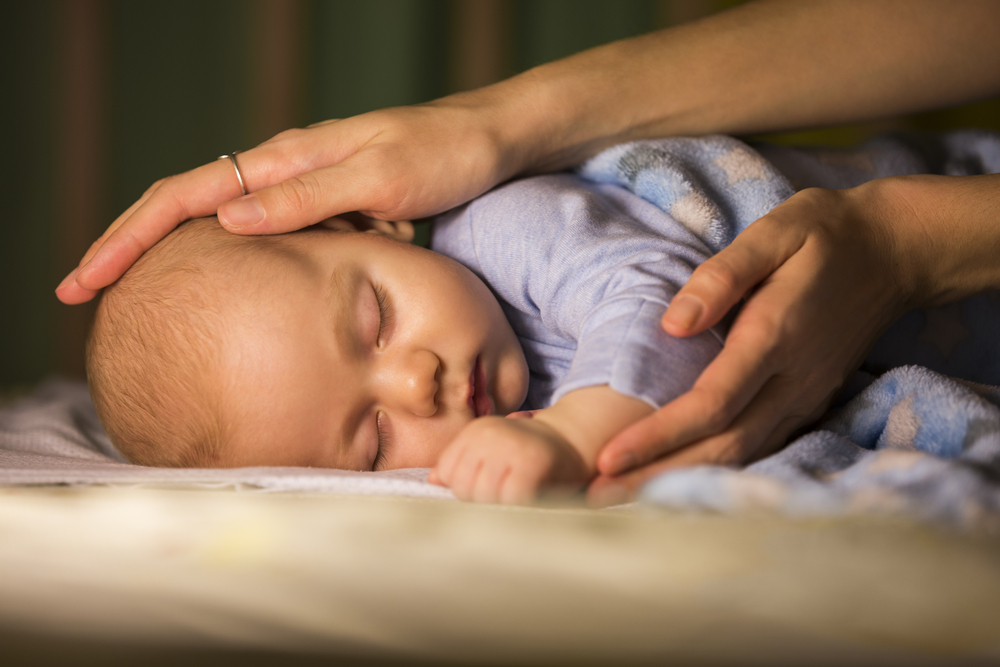 A woman helping her baby sleep better A woman helping her baby sleep better