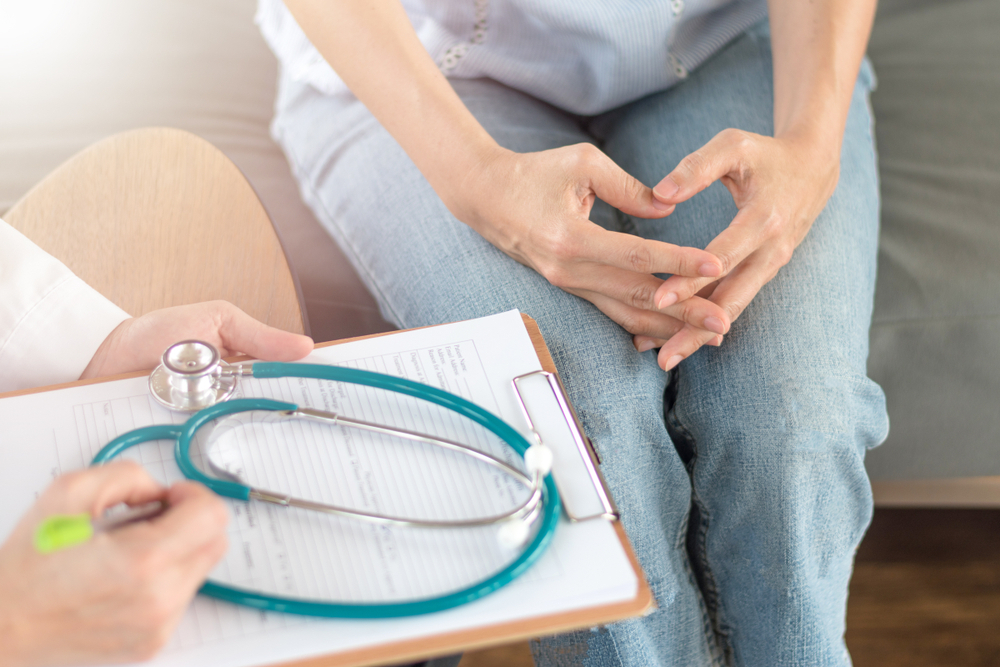 woman consulting her doctor about conception difficulties woman consulting her doctor about conception difficulties