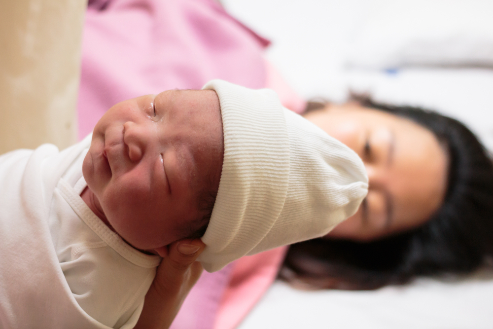 Mother giving birth to a baby Mother giving birth to a baby