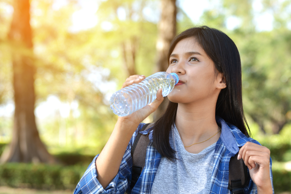 college student drinking water college student drinking water