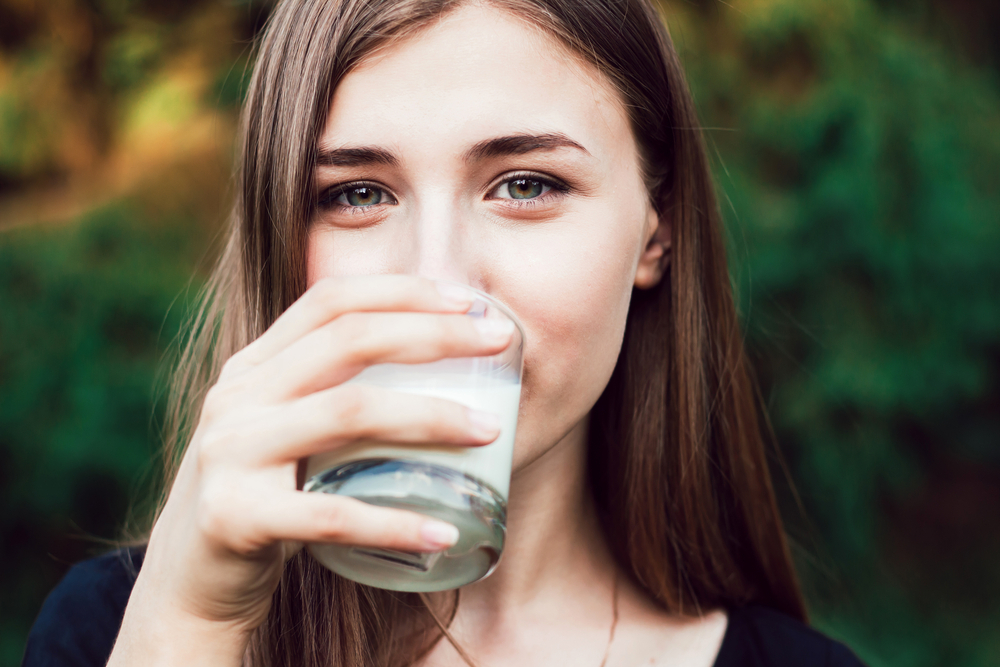 A woman drinking lactose free milk A woman drinking lactose free milk