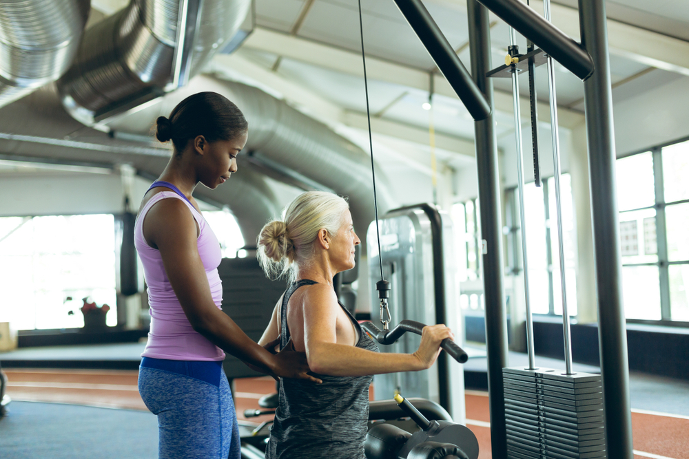 A woman doing wide grip lat pulldown A woman doing wide grip lat pulldown