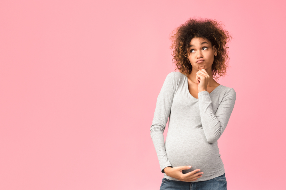 A woman wondering how to get short-term disability approved while pregnant A woman wondering how to get short-term disability approved while pregnant