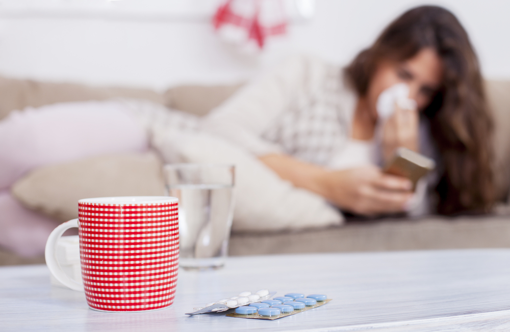 a cup of tea, cold pills, and a woman during breastfeeding stage a cup of tea, cold pills, and a woman during breastfeeding stage