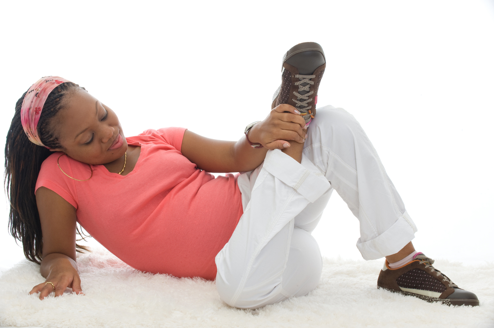 Pregnant woman wearing sneakers Pregnant woman wearing sneakers