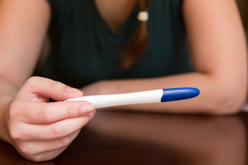 woman holding home pregnancy test 17 DPO woman holding home pregnancy test 17 DPO