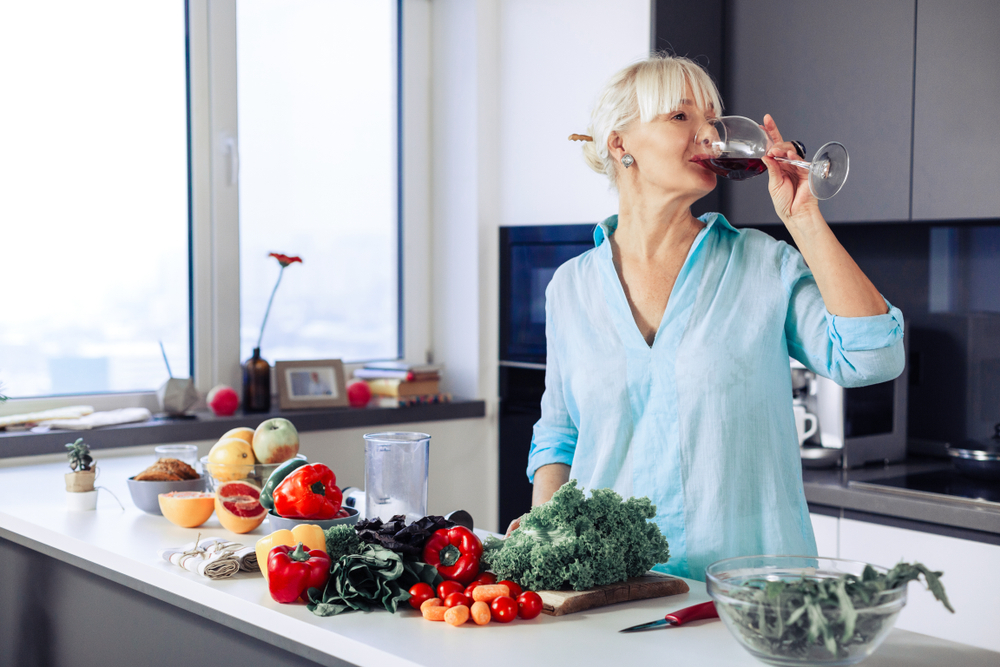 A woman drinking red wine A woman drinking red wine
