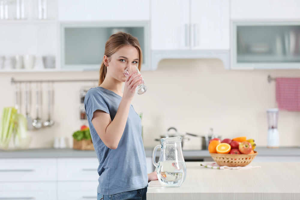 A woman drinking water A woman drinking water