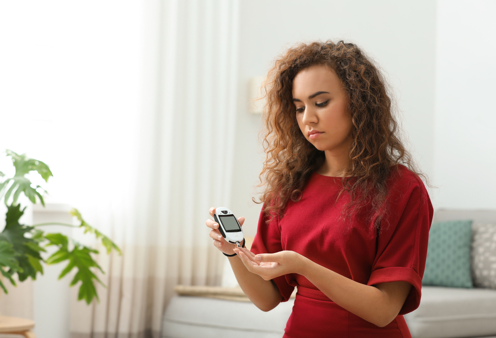 A woman with diabetes checking her blood sugar levels A woman with diabetes checking her blood sugar levels
