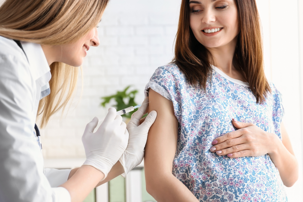 A woman getting a Tdap shot during pregnancy A woman getting a Tdap shot during pregnancy