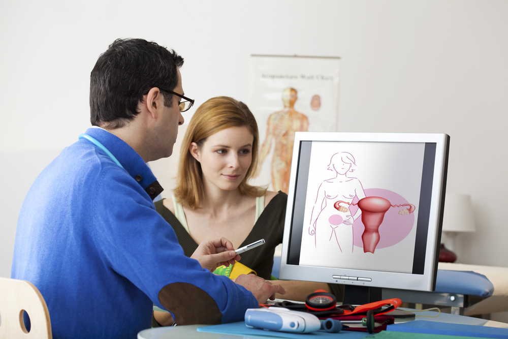 A doctor explains to a woman what a short cervix during pregnancy means A doctor explains to a woman what a short cervix during pregnancy means