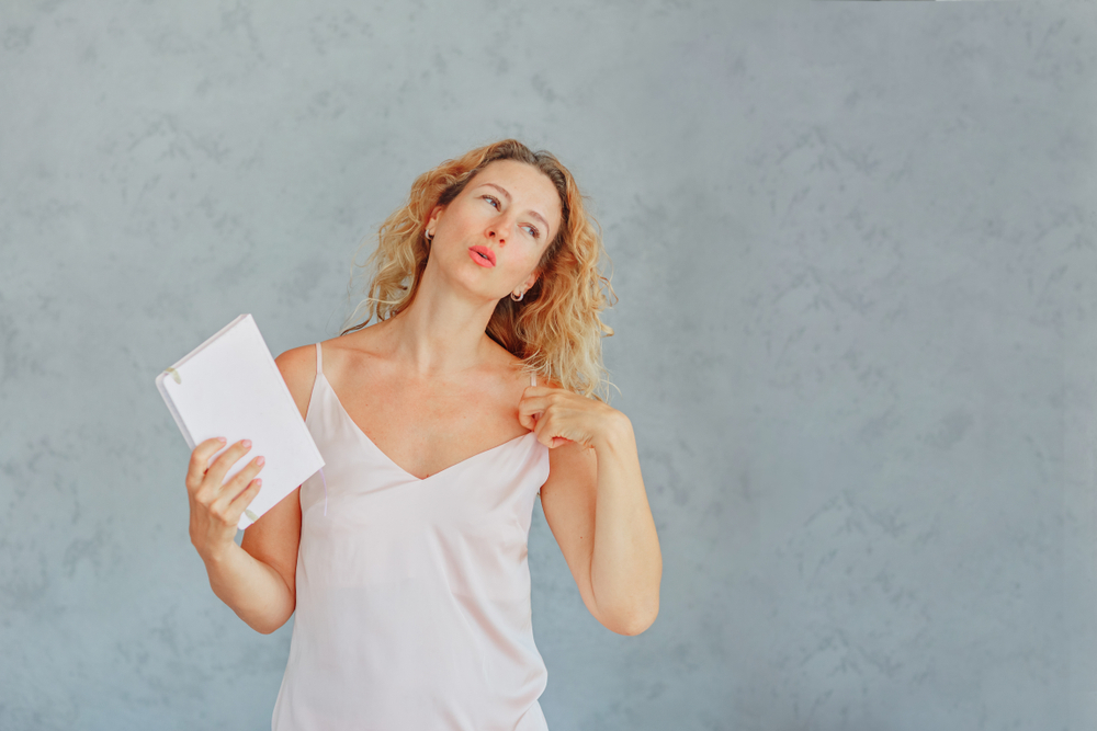 A woman experiencing a hot flash - one of the symptoms of a second puberty in her 40s A woman experiencing a hot flash - one of the symptoms of a second puberty in her 40s
