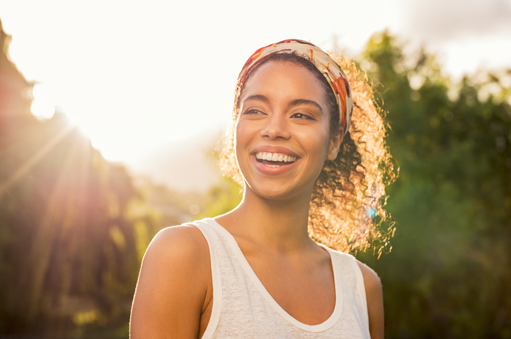 A woman exposuring herself to bright light during the day to improve sleep A woman exposuring herself to bright light during the day to improve sleep
