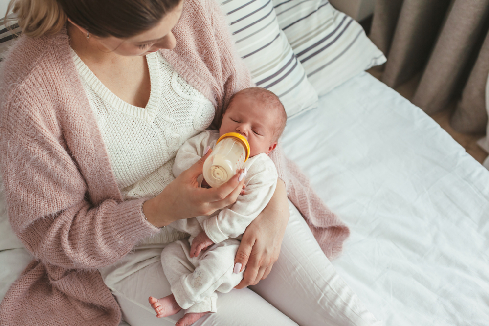 A mom feeds her baby A mom feeds her baby
