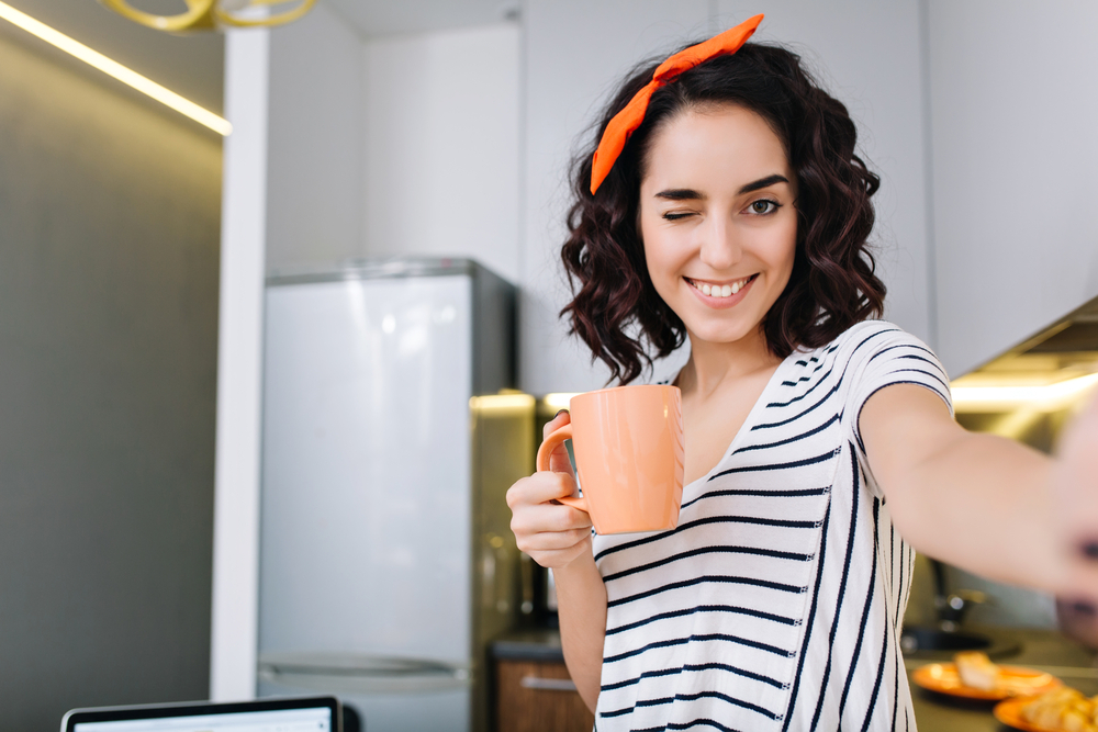 A woman drinks tea on her period A woman drinks tea on her period