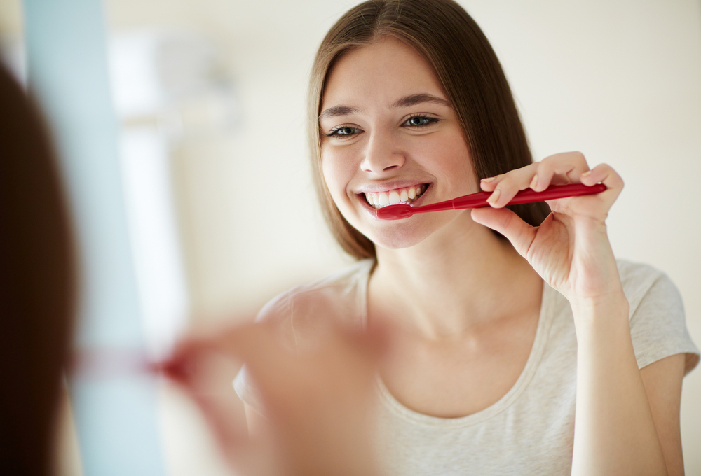A woman using fluoride toothpaste A woman using fluoride toothpaste
