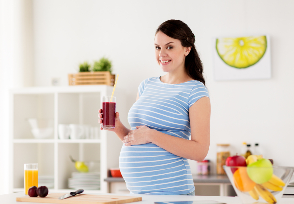 A woman drinking juice during pregnancy A woman drinking juice during pregnancy