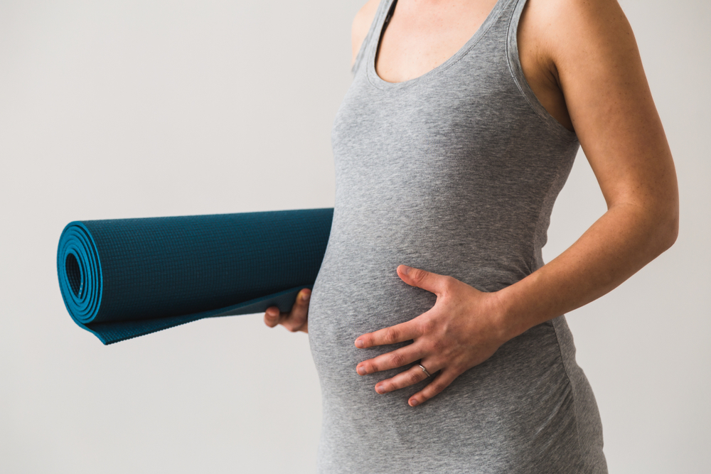 A pregnant woman doing yoga A pregnant woman doing yoga