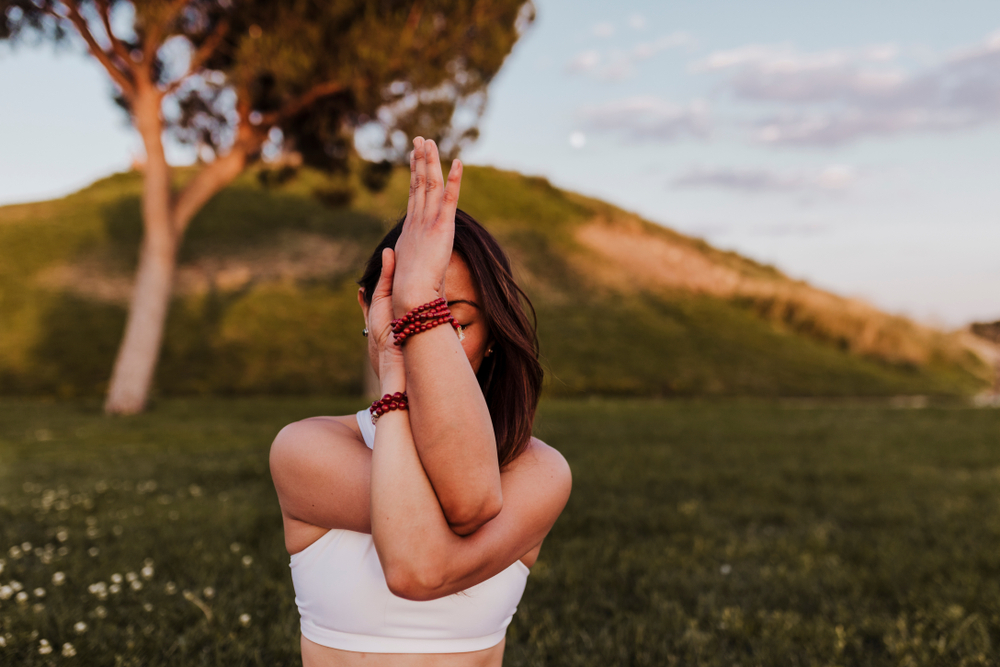 A woman doing deep breathing exercises to help combat stress A woman doing deep breathing exercises to help combat stress