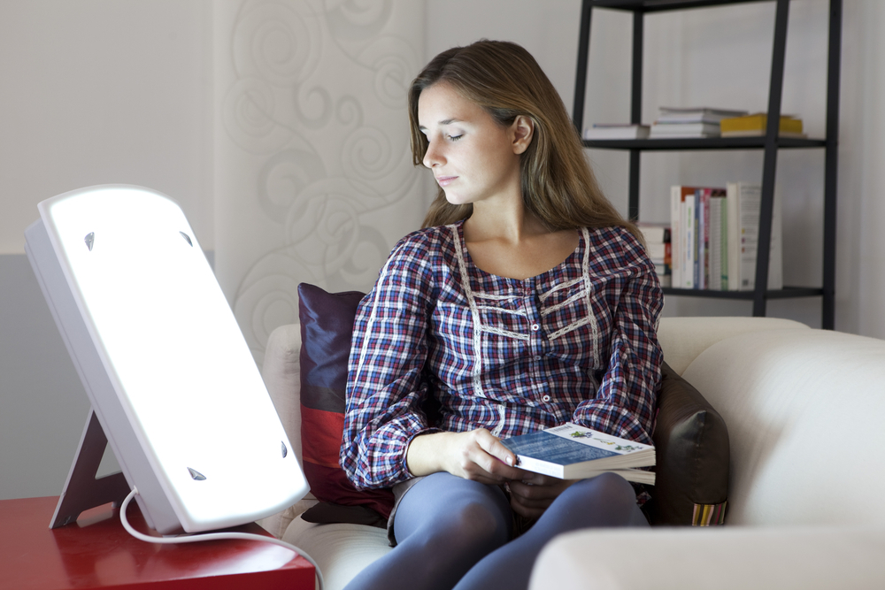woman taking light therapy at home woman taking light therapy at home