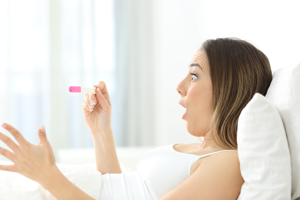 looking at the pregnancy test. looking at the pregnancy test.