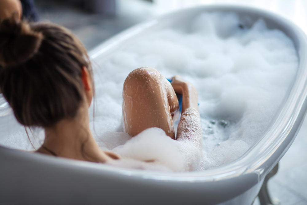 A woman taking a bath to get a good sleep A woman taking a bath to get a good sleep