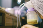 Mother pumping breast milk to store