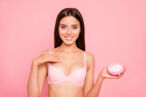 A woman uses topical cream to get rid of chest acne