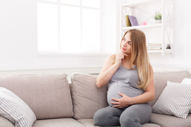 A pregnant woman thinking about the difference between the mucus plug and discharge